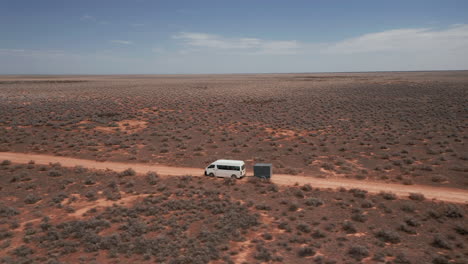 aerial view following a camper and a trailer, sunny day, on a desert, in australia - orbit, drone shot