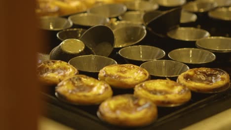 Freshly-baked-Pastel-de-Nata-filmed-in-Lisbon,-Portugal