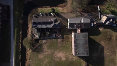 Aerial-perspectives-of-former-youth-prison-facility,-now-abandoned-waiting-for-demolition-and-refurbishment-of-the-moated-plot-field-in-a-residential-neighbourhood-of-Zutphen,-The-Netherlands