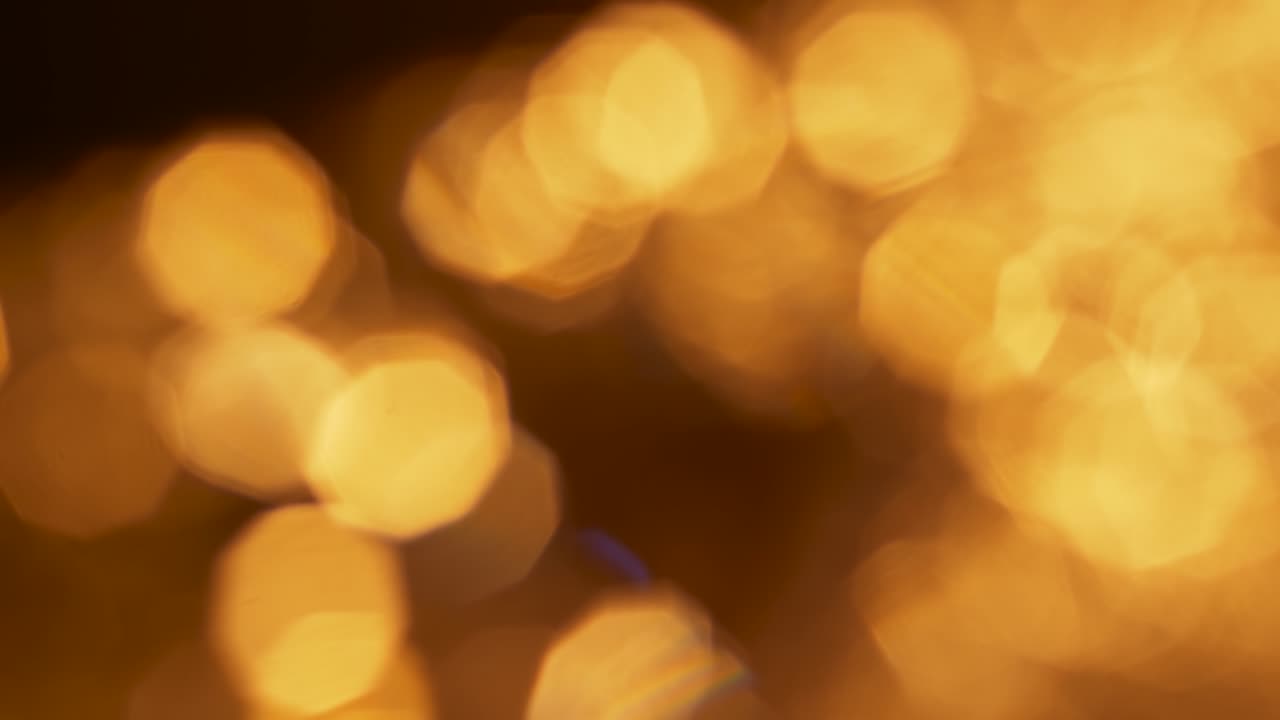 Luci Bokeh Dorate Astratte che Appaiono e Scompaiono