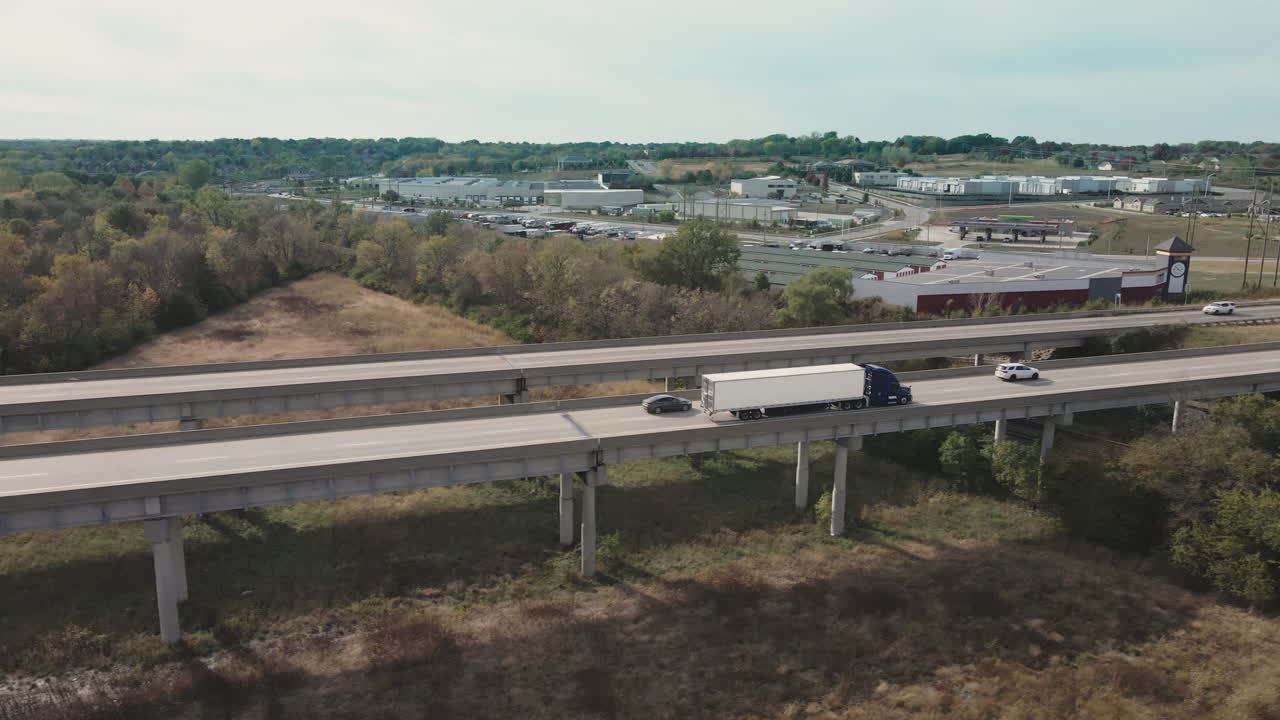 Highway Overpass with Trucks and Cityscape