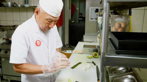 male chef preparing sushi in kitchen 4k