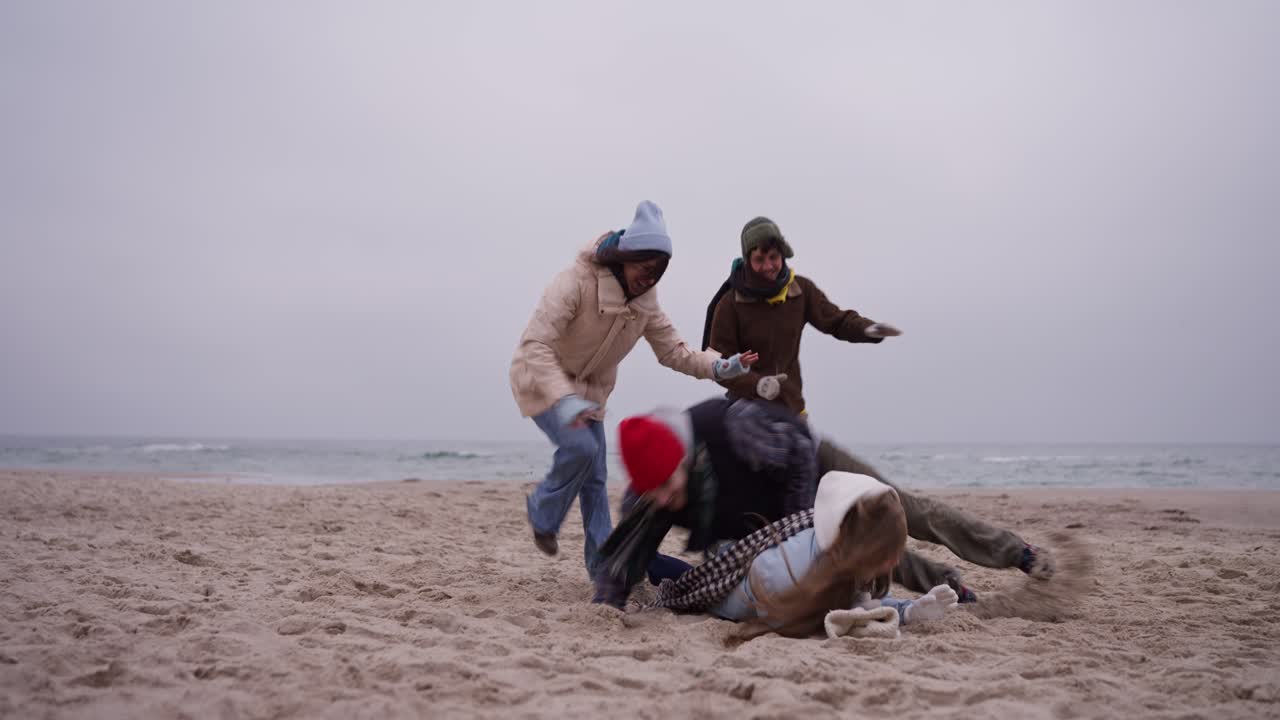 Friends Playing on the Beach in Winter