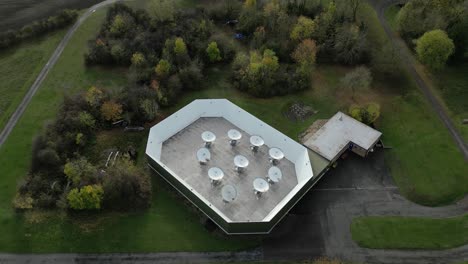 aerial establishing shot of the arcminute microkelvin imager - small array at the mullard radio astronomy observatory