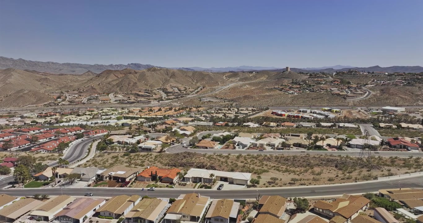 Boulder City Nevada Aerial v7 low flyover above neighborhoods and town streets with Lake Mead and desert mountains on the horizon - Shot with Mavic 3 Pro Cine - Apr 16th 2024