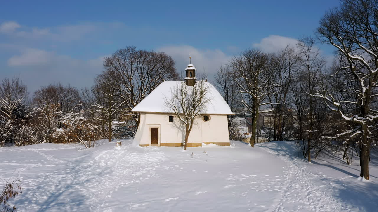 The oldest and smallest church in Krakow with Panorama of snow covered Podgorze district with tenement houses in Krakow, Poland