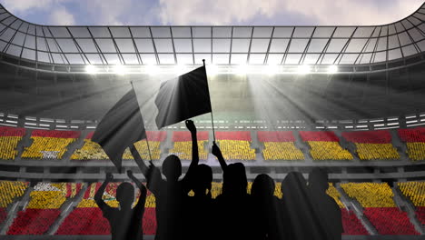 animation of silhouettes of sports fans cheering with spanish flag over sports stadium