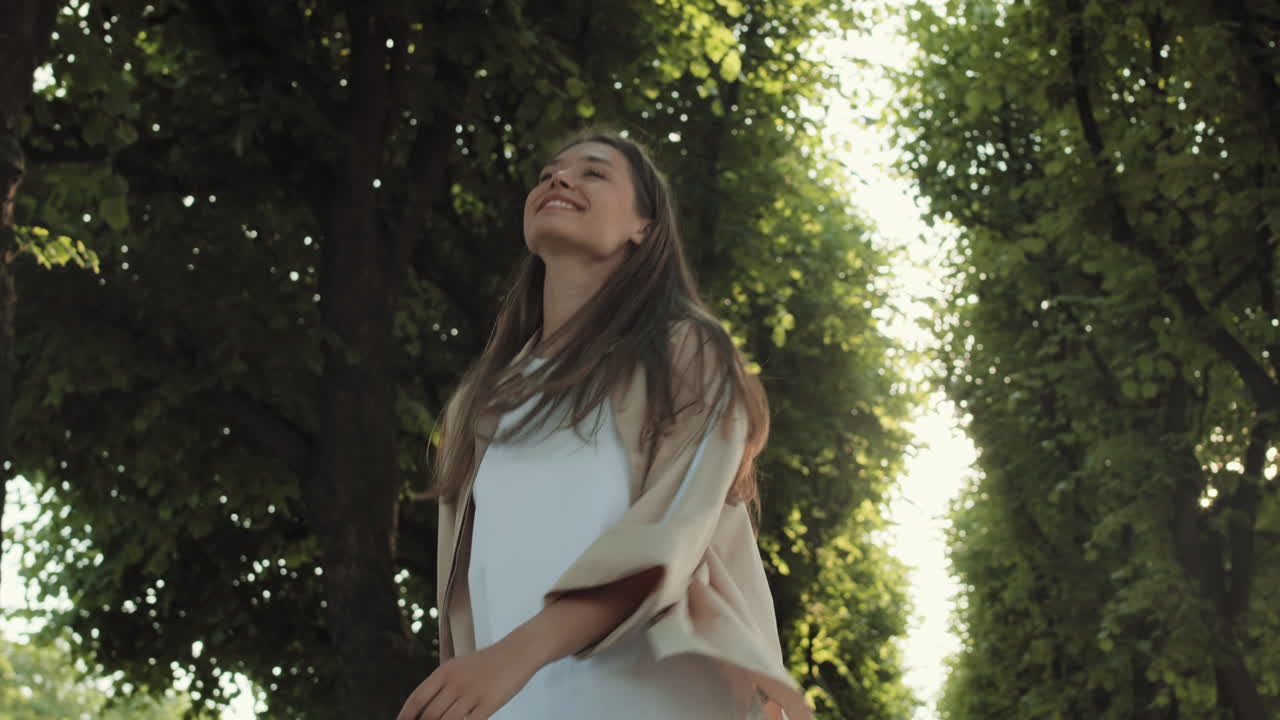 Happy Woman Walking in Green Alley