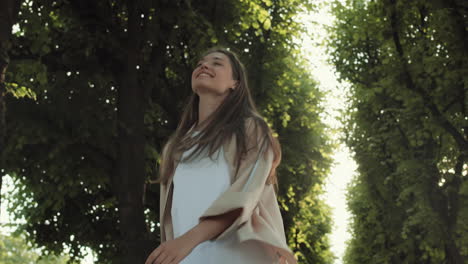 happy woman walking in green alley