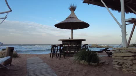 visitors unwind at a cozy cafe located on the azov sea, savoring delicious drinks while taking in the tranquil ocean views and soft sounds of the waves