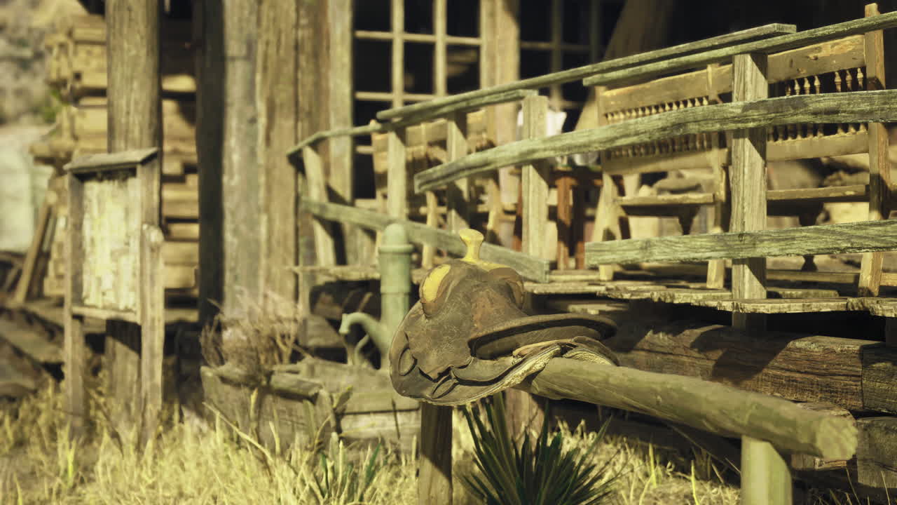Rustic saddle resting on wooden railing near an old western building