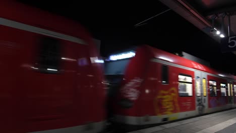a metro train glides through munich’s railway station, with passengers inside, capturing the dynamic rhythm of city travel and urban transit.
