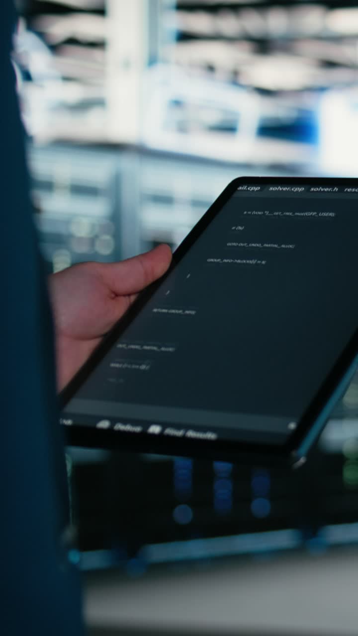 Vertical video Close up of data center engineer using tablet to write code