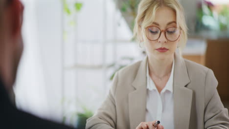woman using calculator while working in office