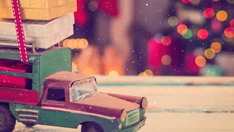 model car with presents on its roof combined with falling snow