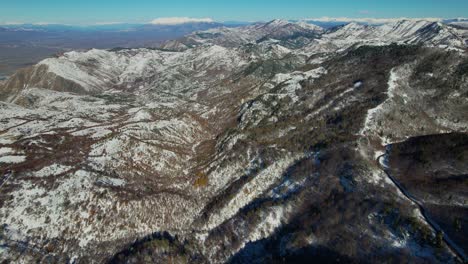 winter's first snow blanket on mountains vast ranges in a serene and snowy landscape in albania