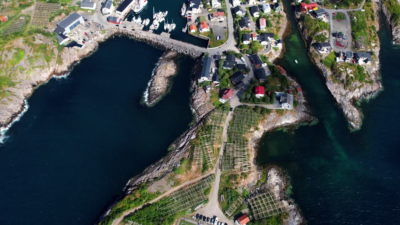 Aerial shot of the Henningsvaer football field with the city coming up behind it