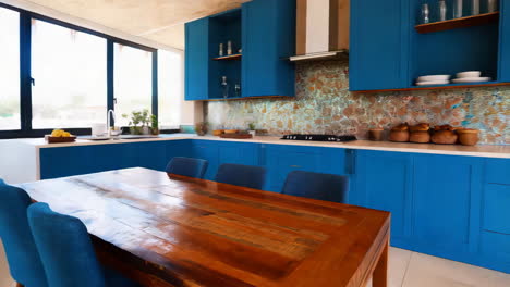 modern kitchen with blue cabinets and wooden dining table