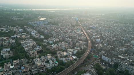 noida city and drone moving closer to metro train bird eye view in noida delhi in india