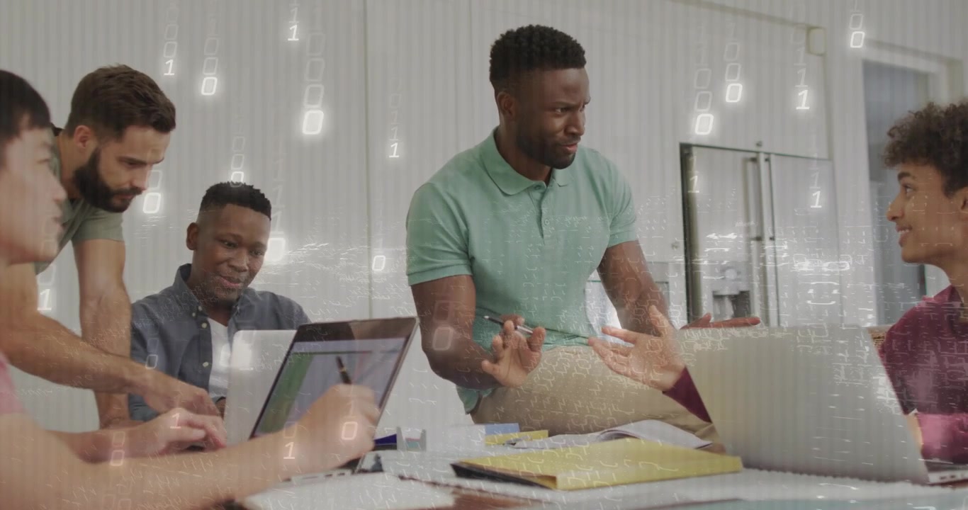 Man in mint polo leading tech review after right peer pointing at laptop binary overlay appearing
