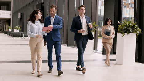 businesspeople going along office hall