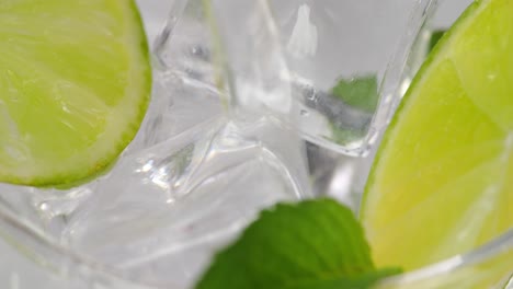 closeup of refreshing cocktail with lime and mint