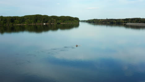 man in his small boat row his way back to the shore of danube river in vukovar croatia