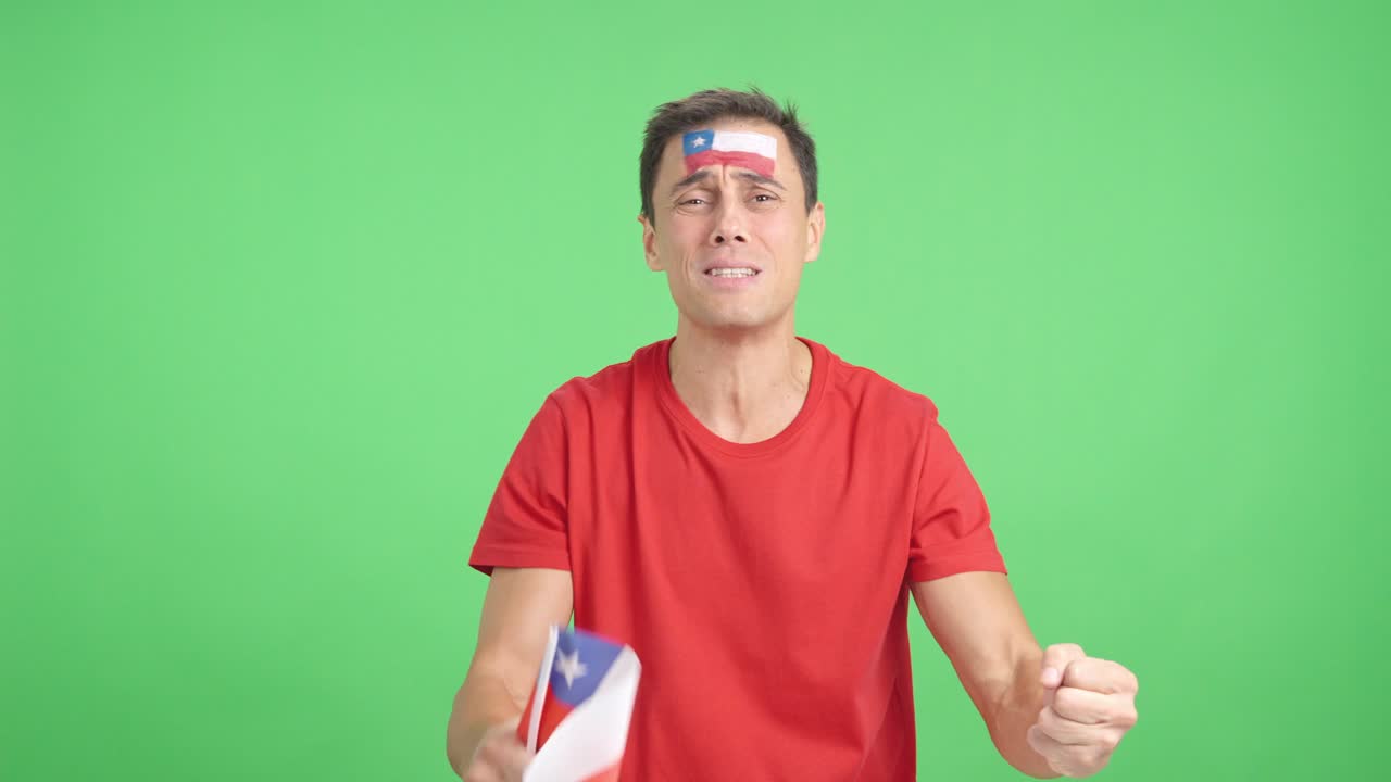 Man cheering for Chile during a match that is lost