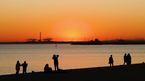 people enjoying sunset at st kilda beach