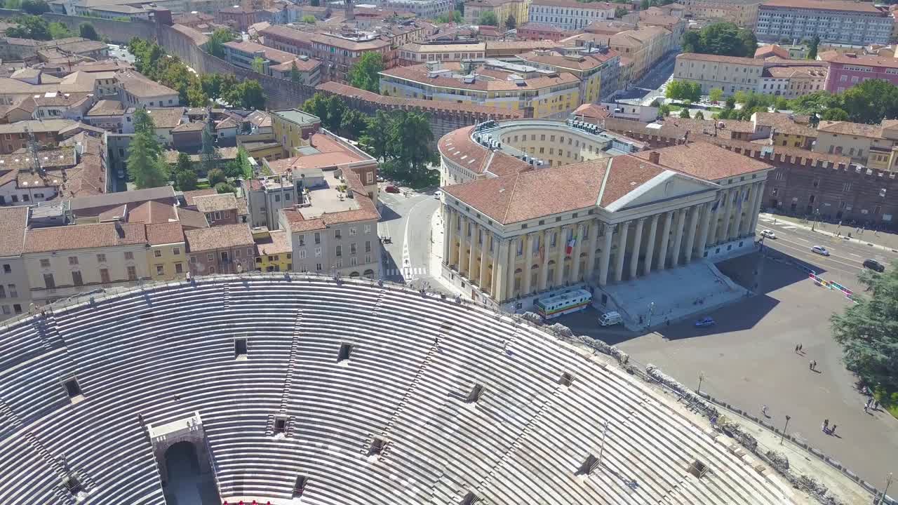 Aerial panoramic view of Arena di Verona, Italy. The drone moves from the Verona City Hall and flies over the Arena. A view of the Arena and the city opens. 4k vieo.