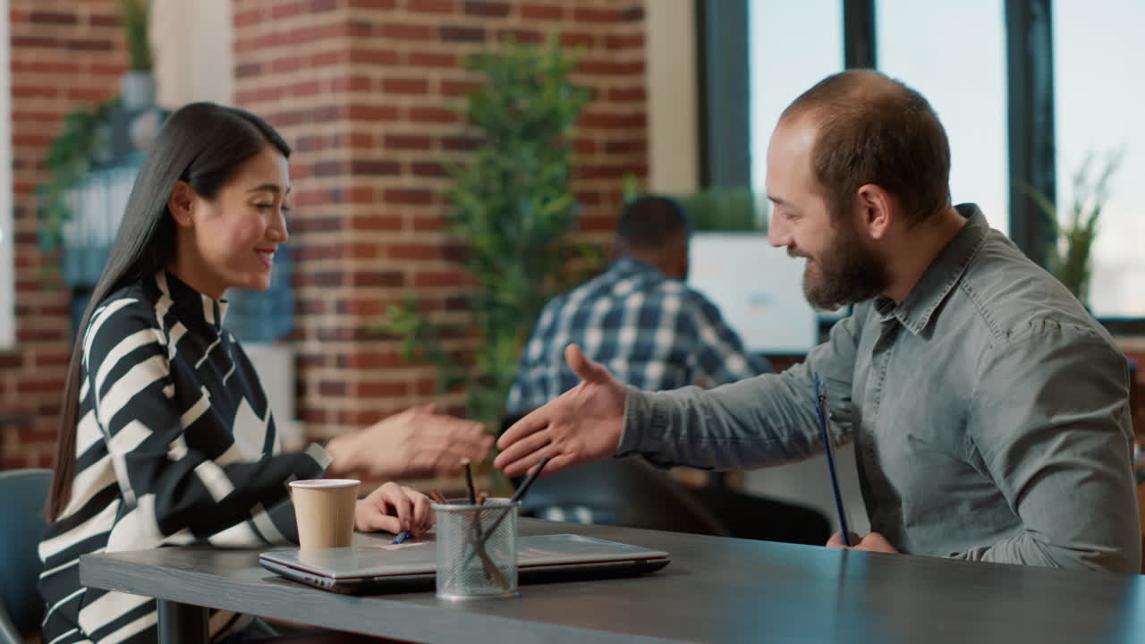 Asian recruiter greeting candidate at job interview meeting