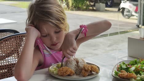 little girl eating lunch at a cafe