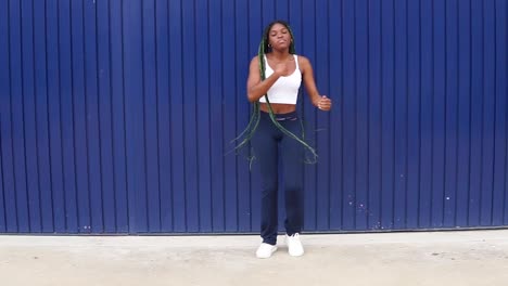 young dynamic black woman dancing on street