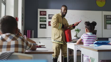 video of happy african american teacher with class of diverse pupils during ohs lesson