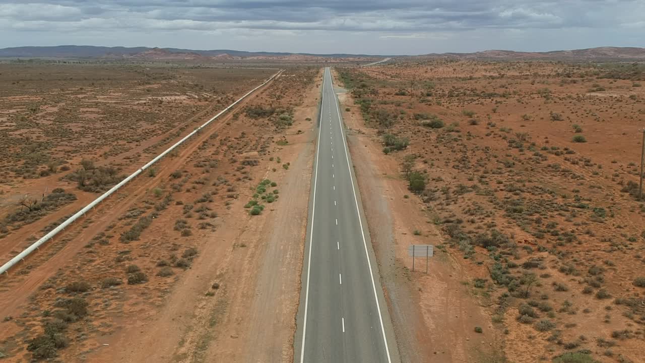 Flying high above and outback road as a truck passing by