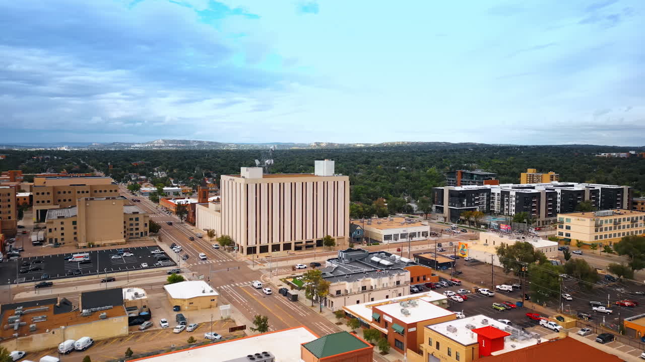 Colorado Springs, USA, 22 July 2025: Flight over the modern cityscape of Colorado Springs, Colorado, USA. Scenery of the city with multiple parking lots