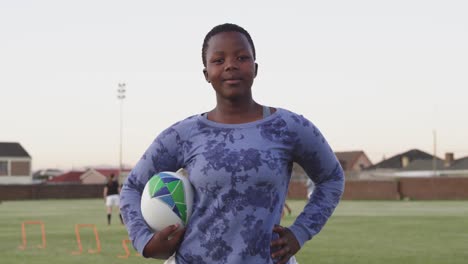 Portrait-of-young-adult-female-rugby-player-on-a-rugby-pitch