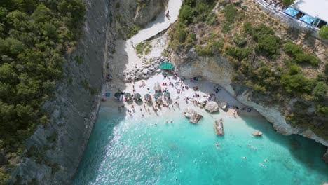 golden sandy beach in zante, greece with people relaxing and swimming