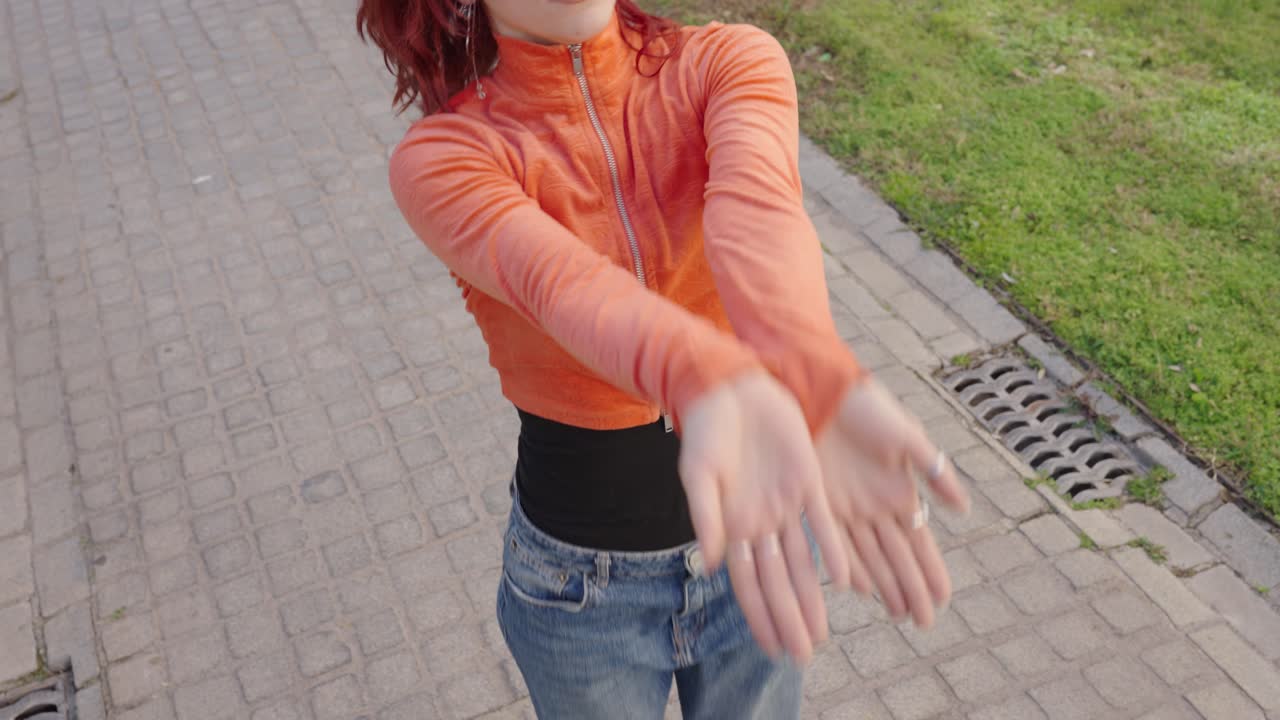 Redhead dancer performing modern dance routine outdoors