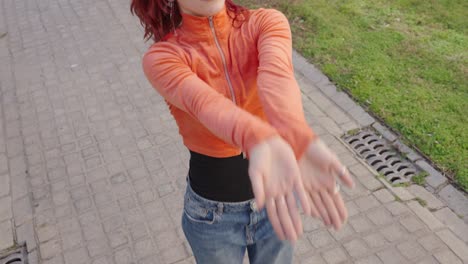 redhead dancer performing modern dance routine outdoors