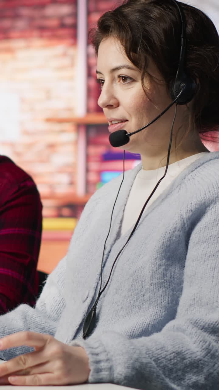 Vertical video Call center team leader going over paperwork files