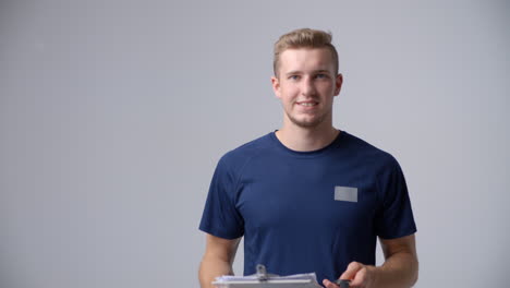 Slow-Motion-Sequence-Of-Male-Sports-Coach-With-Clipboard