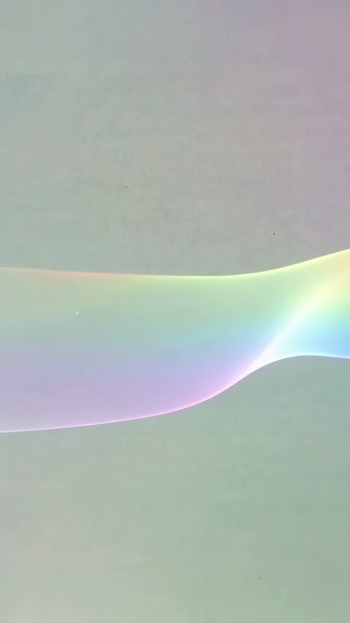 Vertical video: Shifting ribbon responding to frame progression, morphing across pale display panel