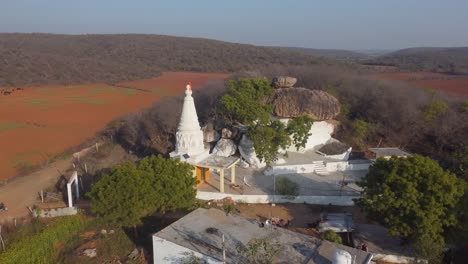 aerial drone shot of a ancient hindu temple surrounded by farms in a village of madhya pradesh india