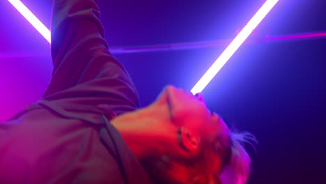 Cool-woman-performing-hip-hop-in-neon-lights-close-up.-Girl-dancing-freestyle.