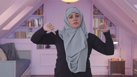 disappointed muslim woman showing thumbs down