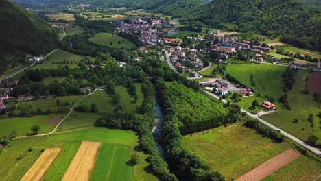 forward drone shot above ponte san quirino fields and mountains, italy