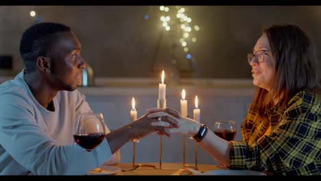 romantic interracial couple enjoying a candlelit dinner