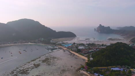 aerial view of a tropical island with boats and village