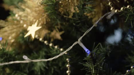 christmas tree with gold tinsel and decorations